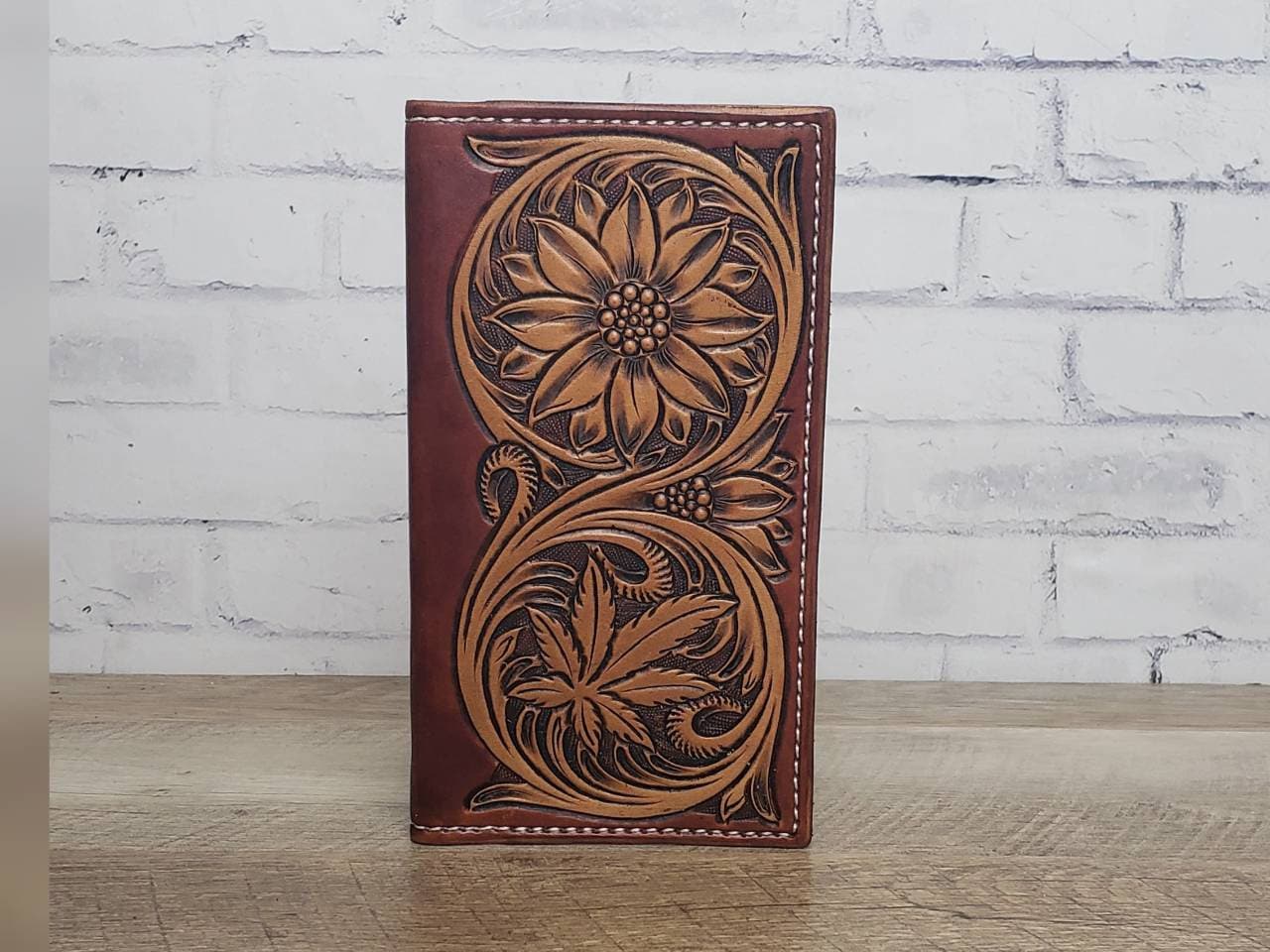 Tall leather roper wallet with tooled sunflower and cannabis leaf pattern