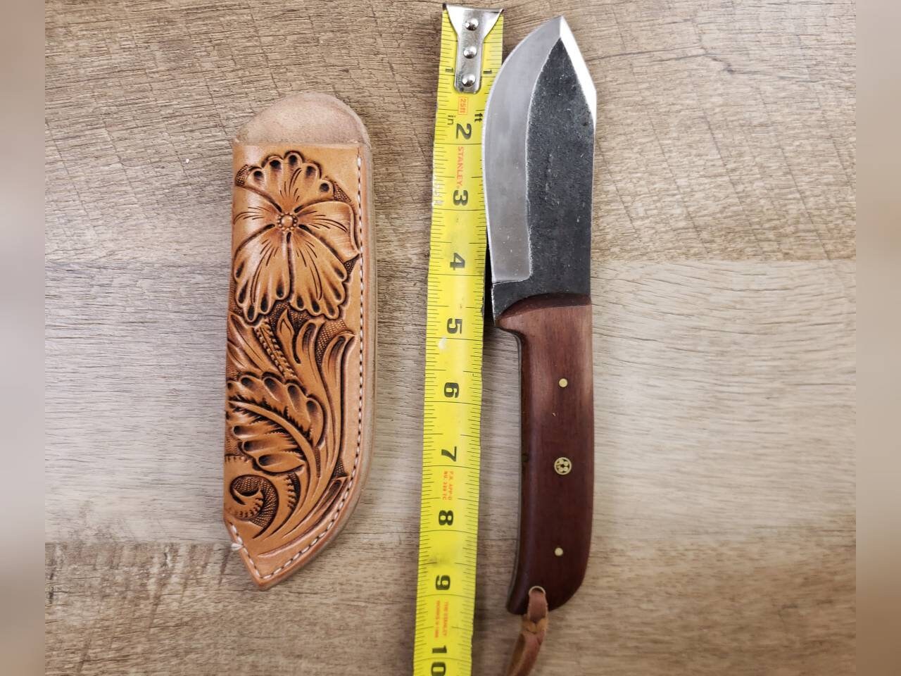 1095 forged hunting knife with a tooled leather angled sheath