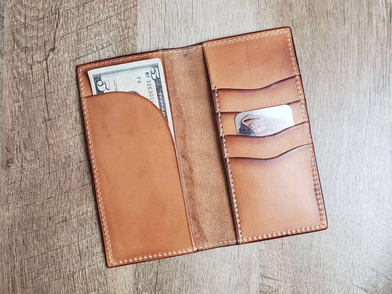 Tall leather roper wallet with tooled sunflower and cannabis leaf pattern