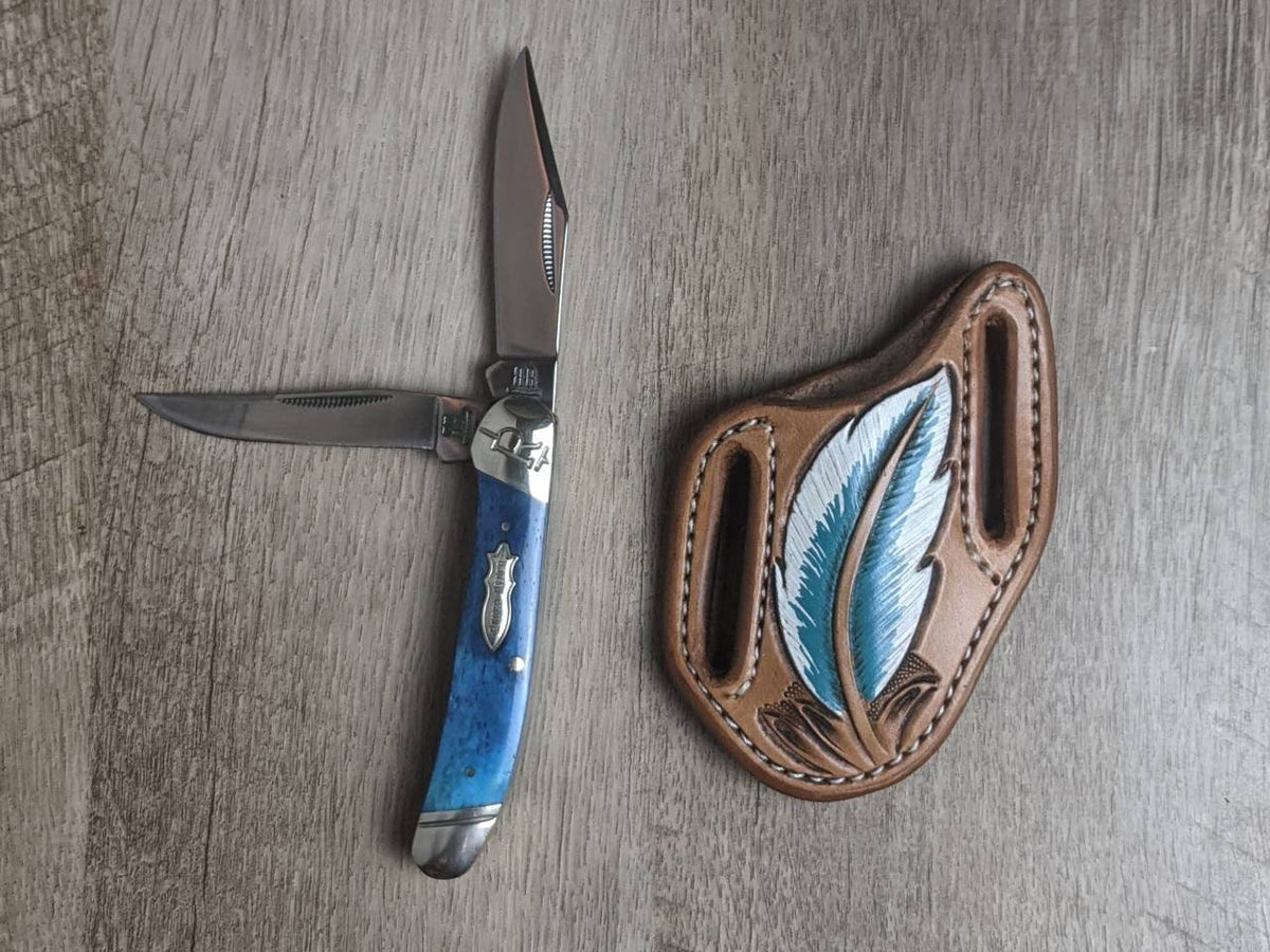 Turquoise bone handled Rough Rider Trapper knife with matching painted feather Leather Pancake Style sheath