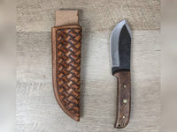 1095 forged hunting knife with a tooled basket weave leather straight hang sheath