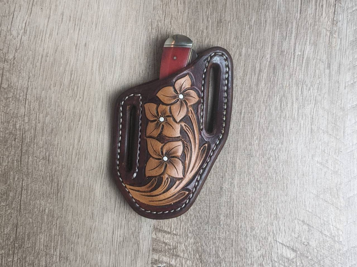 Red bone handled Rough Rider Trapper knife with matching painted floral carved chocolate Leather Pancake Style sheath